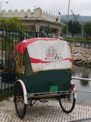 A rickshaw outside the Maritime Museum sports a Coca-Cola ad.