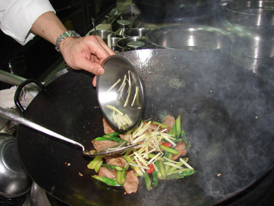Stir-frying the sliced duck. Photos by Sandra Scott