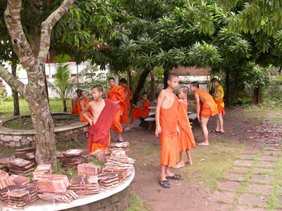 Novice monks taking a break from repairing a temple roof.