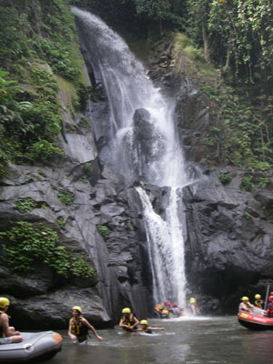 Enjoying a peaceful break at a waterfall during a white-water rafting trip in Bali.
