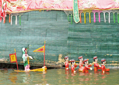 Water puppets parade in front of the stage screen that hides the puppeteers — Museum of Ethnology, Hanoi. Photos: Patten