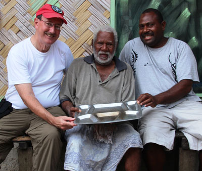 Lew Toulmin with Chief Vincent Taissets and his son Walter. A US Navy mess tray is one of the chief’s only souvenirs from his service during WWII.