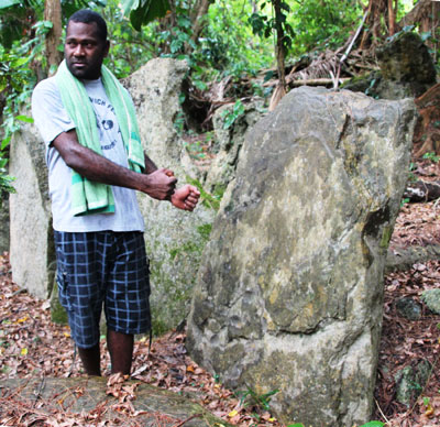 Etienne Tiasinmal beside his family stone in a nasara on Wala island. Photos: Toulmin