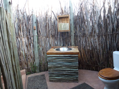 Our bathroom facilities at Camp Kwando were open to the sky (and rain).