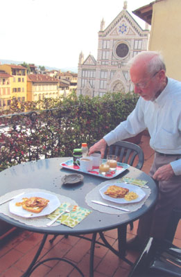 With the Church of Santa Croce in the background, Julie’s husband, Paul, is setting out breakfast on the terrace of their apartment in the Palazzo Antellesi — Florence. Photos: Skurdenis