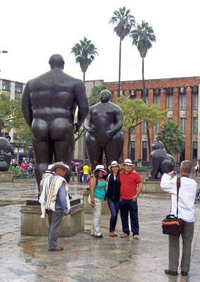 Visitors posing by Botero sculptures in Plaza Botero — Medellín.