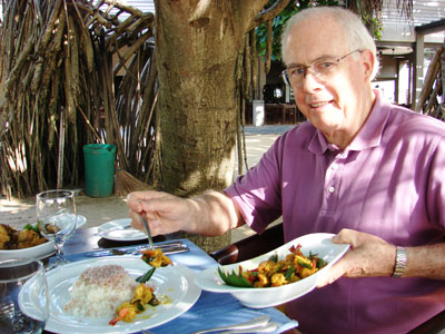 John Scott dining on Negombo Prawn Curry.