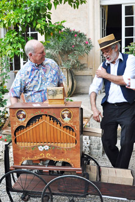 Cliff Weathers playing a barrel organ at a party at the Château d’Agel.