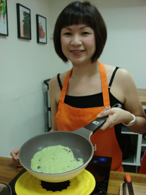 Instructor Lena Tan with a Kueh Dadar pancake. 