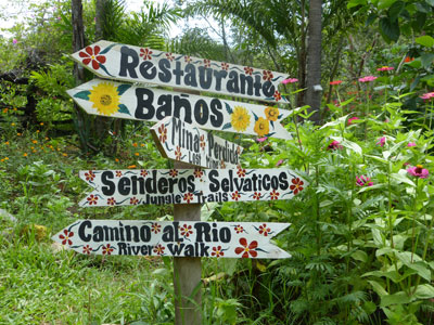 A signpost bristling with directions to various parts of the gardens.