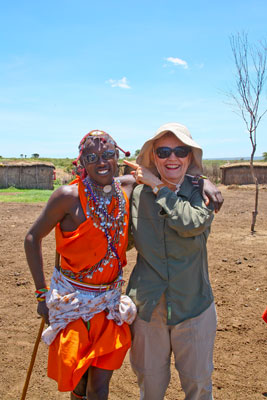 The young Maasai who got the cologne and sunglasses posing with Claudia Reed — Kenya.
