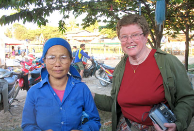 After receiving a pair of reading glasses from a group member, this Laotian lady, standing beside Peg Sonnek, placed her hands over her heart as a sign of thanks. Photo by Bernard Sonnek