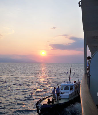 The Corinth Canal tugboat moors alongside the Athena in the Ionian Sea.