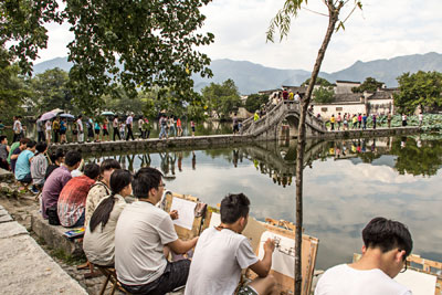 Students painting by the lake in Hongcun.
