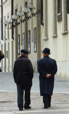 Two gentlemen walking and talking in the lakeside town of Como. 