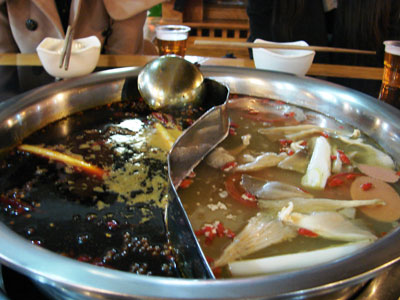 In the Chongqing food mall, the divider in this hot pot kept the spicy broth separated from the mild.<br />
