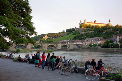 Bring a picnic to the riverbank in Wuerzburg, Germany, to enjoy a fortress view and convivial people.