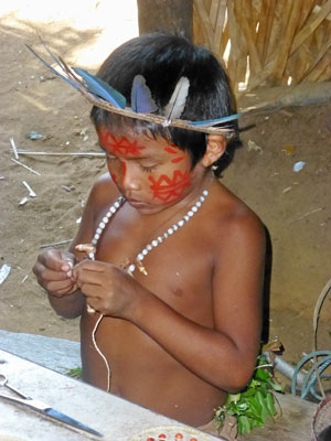 At his village on the Rio Negro, a Tatuyo tribe boy in traditional costume.