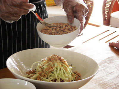 Adding nuts to the Ginger Salad.