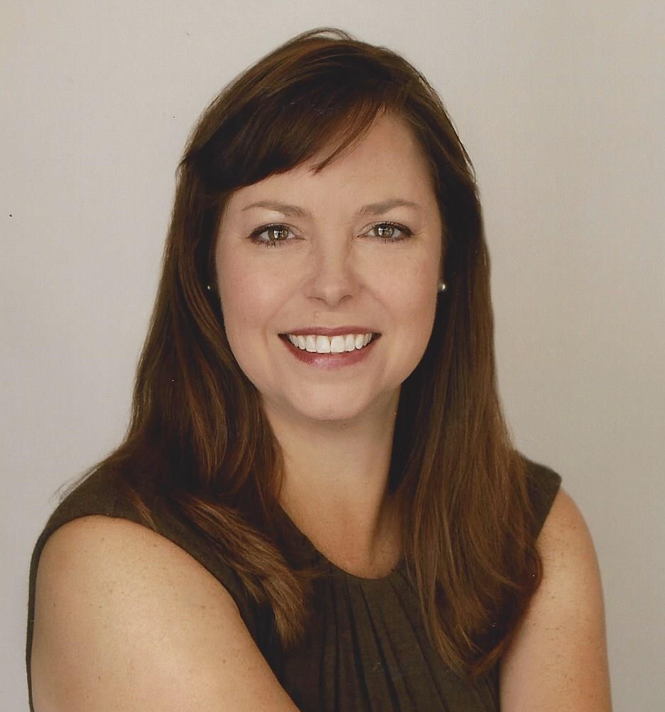 woman with brown hair wearing a brown top