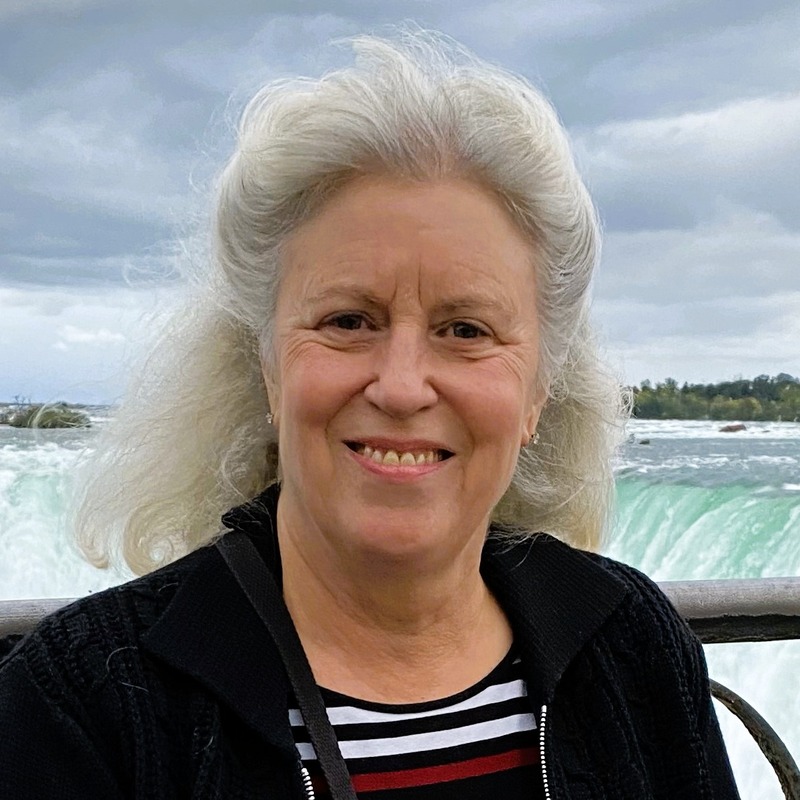 woman with white hair and waterfall in the background