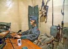 A mannequin holding 1940s communication gear sits inside Fortress Furigen, a decommis-sioned bunker near Luzern that provides a peek at Switzerland’s hidden defense system.