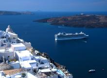 A cruise ship offers memorably fantastic views of the classic whitewashed villages of Santorini. Photo by Cameron Hewitt