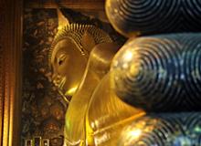 Toes of the 46-meter-long reclining Buddha at Wat Pho temple in Bangkok, Thailand. The figure was built with bricks, shaped with plaster, then gilded.