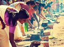 Women cooking at a religious festival in Kerala, southwestern India.