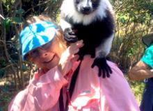 Libby Cagle with a lemur on her shoulder, at Varuna Resort in Madagascar. Photo by Roger McDaniels