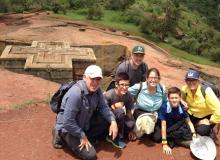 Bob, Addis, Matt, Anna, Javi and Joan kneeling above the Church of St. George in Lalibela, Ethiopia. Photo by Tefera Alemu