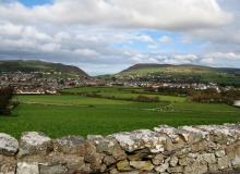 Suburban homes near Port St. Mary spread across a picturesque valley.