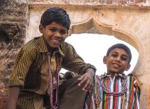 Indian “hotel boys” showed off their climbing skills while wearing my necklace gifts. Photo by Donna Judd