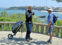 On a headland in Biarritz, France, in June 2015, Randy Keck (right) chatted with the Dutchman Gysbert Haaksman, who was on a 2,500-kilometer pilgrimage from the Netherlands to Santiago de Compostela, Spain, pulling a 30-pound backpack apparatus that had a single wheel. 