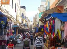 Visitors exploring the colorful medina in Essaouira. Photo by Randy Keck