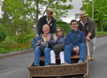 Stan Kimer (left) and two British friends riding the toboggan down the hill into Funchal.