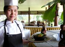 Chef Myint Oo and a bowl of the Rakhine Hot and Spicy Chicken Curry with garnish. Photos by Sandra Scott