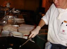 Chef Teng stirring in prawns and squid.