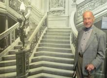 My husband, Paul Lalli, in front of a photo of the grand staircase of the <i>Olympic</i>, sister ship of the <i>Titanic</i> — Maritime Museum of the Atlantic, Halifax. Photos by Julie Skurdenis