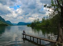 Our friend Brenda sitting on a pier on one of the many lakes we visited.