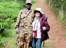 Marlene Snedaker and a ranger in Kibale National Park, Uganda. Photo by Umar Kalule (driver)
