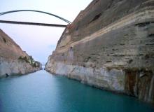 A motor bridge spans the Corinth Canal’s nearly 300-foot-high limestone walls about halfway through the transit. Photo: Bowman