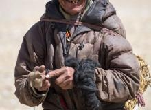 Tibetan man making a spool of wool from yak hair (in China). Photo ©piccaya/123rf.com