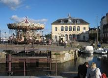 Colorful carousel at Honfleur&rsquo;s old port.