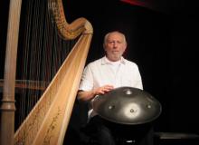 Harpist Luc Vanlaere, with a hang in his lap, in Bruges, Belgium. 