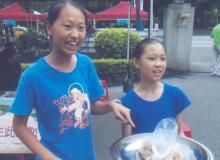 Girls selling food at the Holy Family Catholic Church yard sale — Taipei. Photo by Kevin O’Brien