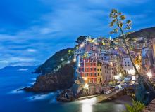 Riomaggiore, one of the Cinque Terre towns, is aglow at night. Photo by Dominic Arizona Bonuccelli