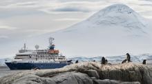 The Sea Spirit glides by a glacier.