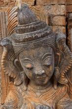 Carving of a guardian spirit on the wall of an ancient stupa in Inn Thein (Indein) village at Inle Lake in Myanmar. Photo: ©Steve Estvanik/123rf.com