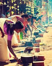 Women cooking at a religious festival in Kerala, southwestern India.